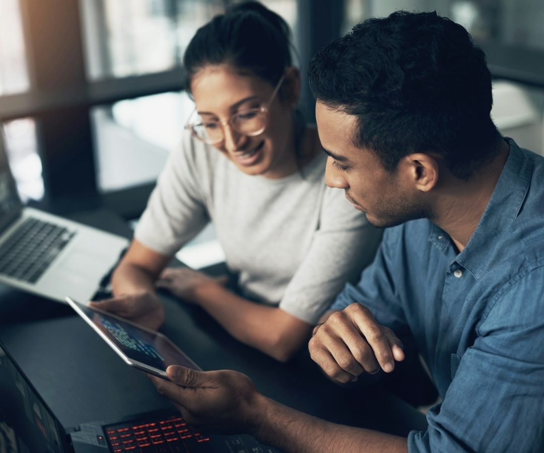 shot-of-two-young-workers-using-a-digital-tablet-in-a-modern-office.jpg